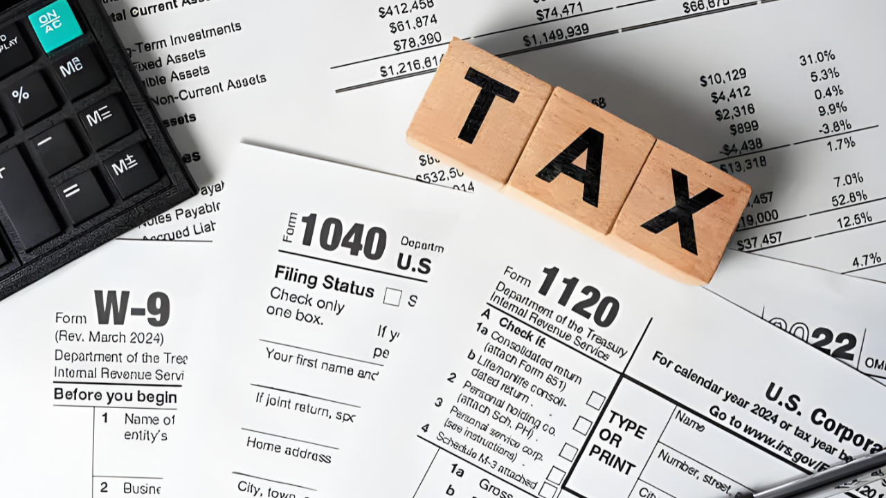 Stack of unfiled tax return documents and forms on desk