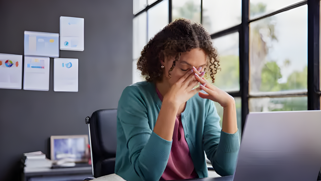 Person stressed looking at financial documents and calculator