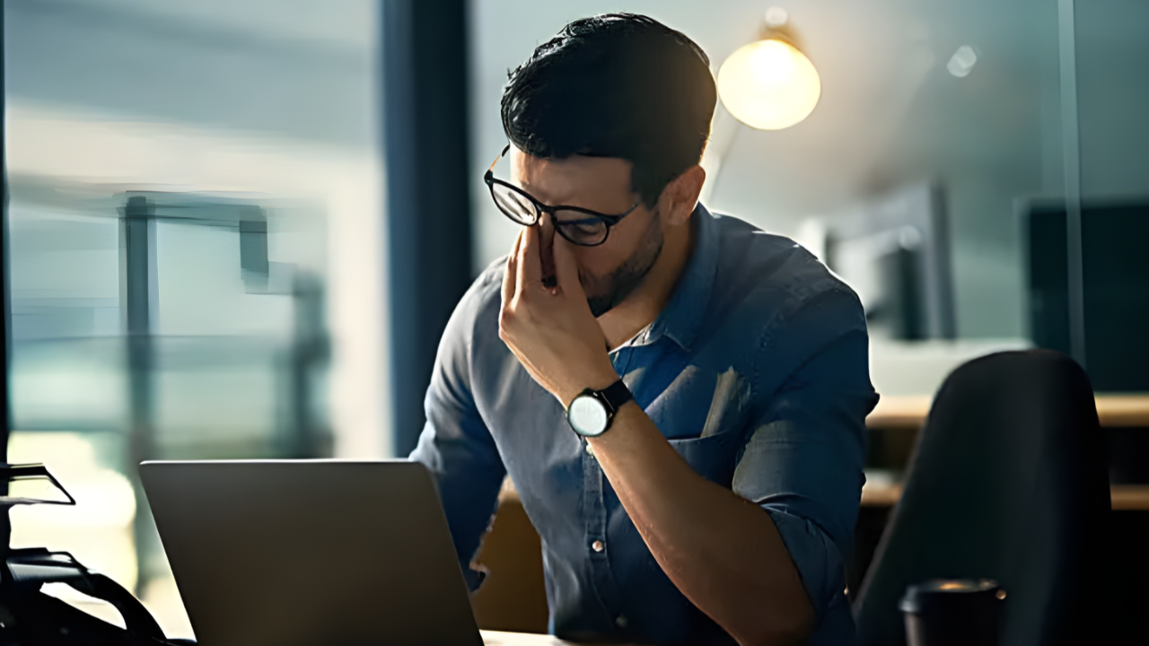 Person stressed about being behind on taxes looking at documents
