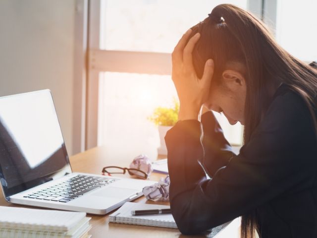 Woman worried about Tax Identity Theft at her desk