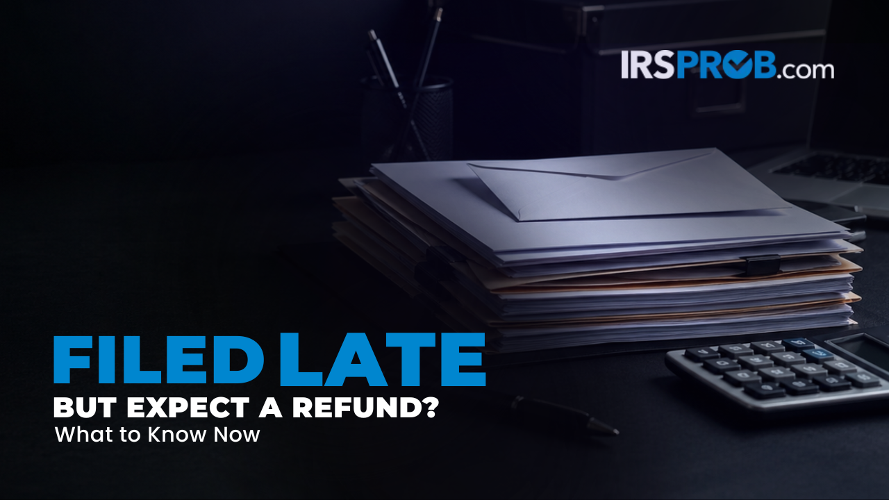 Tax documents, calculator, and refund paperwork for a blog about filing late but expecting a refund